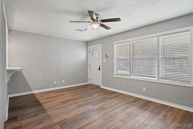 345 N Pine, Dewey, OK 74029 - entrance foyer featuring a ceiling fan, wood finished floors, and a textured ceiling