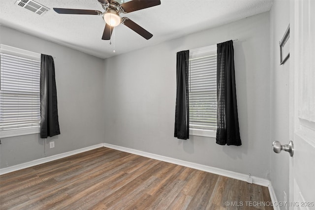 345 N Pine, Dewey, OK 74029 - spare room featuring wood finished floors and ceiling fan