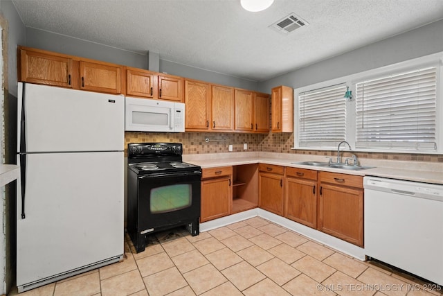 345 N Pine, Dewey, OK 74029 - kitchen with white appliances, light countertops, decorative backsplash, and a textured ceiling