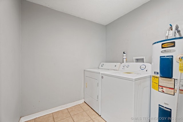 345 N Pine, Dewey, OK 74029 - laundry area featuring electric water heater, washing machine and dryer, and light tile patterned floors