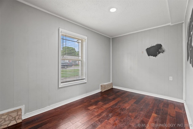 345 N Pine, Dewey, OK 74029 - empty room featuring dark wood-type flooring and a textured ceiling