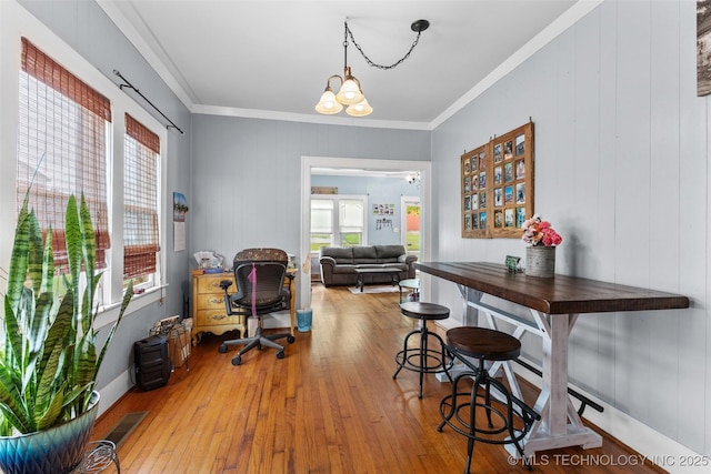 817 S Stockton, Ada, OK 74820 - office space featuring plenty of natural light, wood-type flooring, ornamental molding, and a chandelier