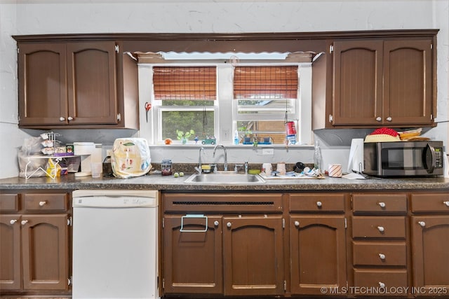 817 S Stockton, Ada, OK 74820 - kitchen featuring white dishwasher and dark countertops
