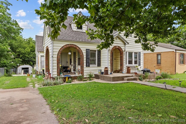 817 S Stockton, Ada, OK 74820 - view of front facade featuring a shingled roof and a porch
