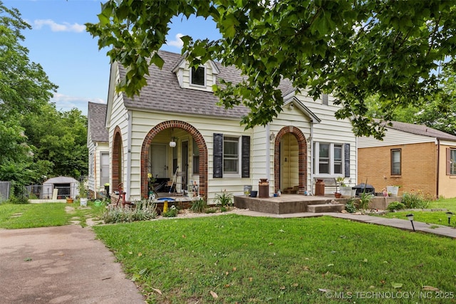 817 S Stockton, Ada, OK 74820 - view of front of property with roof with shingles, covered porch, and brick siding