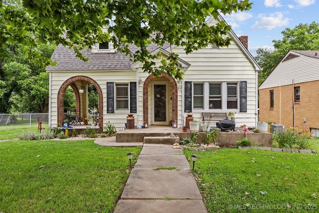 817 S Stockton, Ada, OK 74820 - view of front of property with a shingled roof, a porch, and a chimney