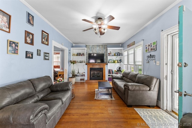 817 S Stockton, Ada, OK 74820 - living area with ceiling fan, crown molding, wood finished floors, and a fireplace
