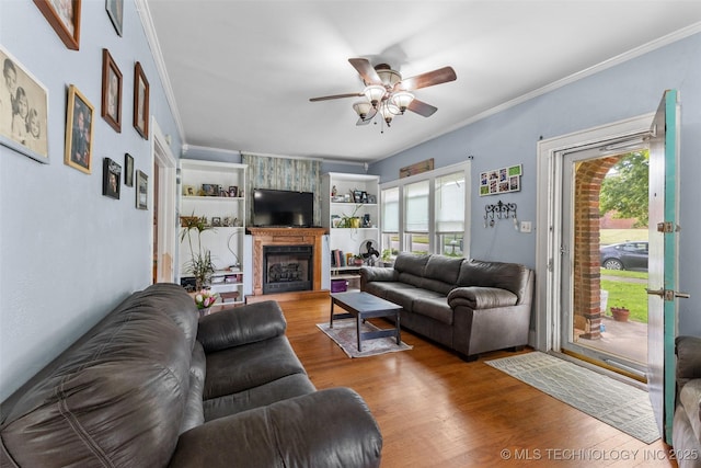 817 S Stockton, Ada, OK 74820 - living area featuring ceiling fan, crown molding, wood finished floors, and a fireplace