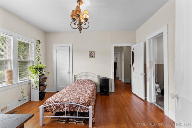 817 S Stockton, Ada, OK 74820 - bedroom with a chandelier and wood finished floors