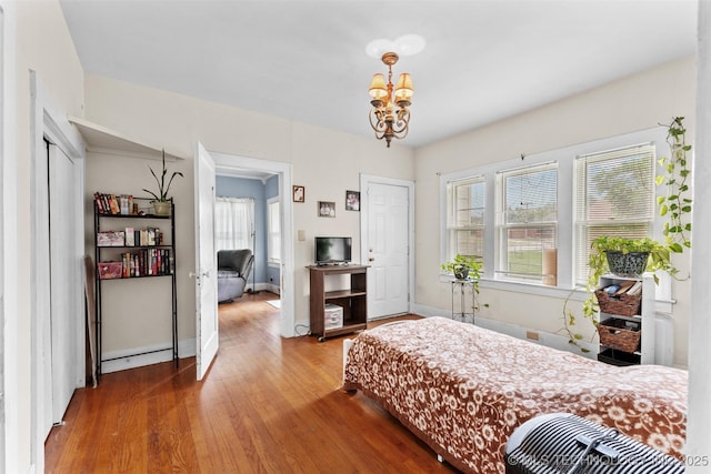 817 S Stockton, Ada, OK 74820 - bedroom with wood finished floors and a chandelier