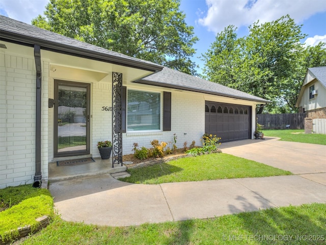 5610 S 75th E Pl, Tulsa, OK 74145 - view of front of home featuring brick siding, a garage, concrete driveway, and roof with shingles
