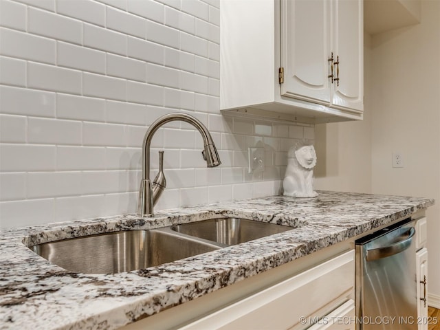 5610 S 75th E Pl, Tulsa, OK 74145 - kitchen featuring stainless steel dishwasher, backsplash, light stone countertops, and white cabinets