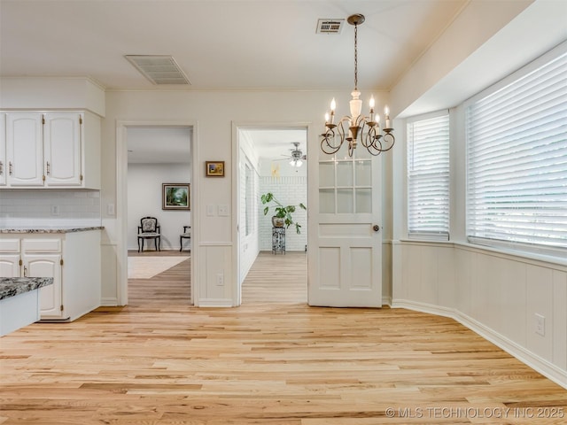 5610 S 75th E Pl, Tulsa, OK 74145 - dining space featuring light wood-style flooring, a chandelier, ceiling fan, ornamental molding, and wainscoting