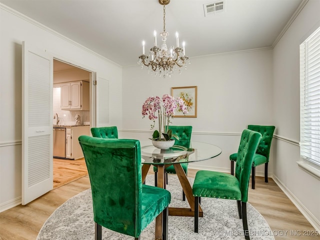 5610 S 75th E Pl, Tulsa, OK 74145 - dining room with a chandelier, light wood-type flooring, and ornamental molding