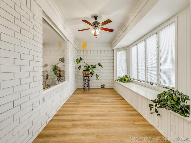 5610 S 75th E Pl, Tulsa, OK 74145 - sunroom / solarium with brick wall, wood finished floors, and ornamental molding