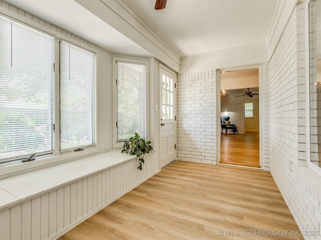 5610 S 75th E Pl, Tulsa, OK 74145 - unfurnished sunroom featuring wood finished floors, crown molding, and brick wall