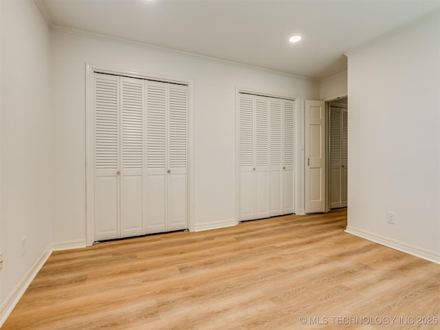 5610 S 75th E Pl, Tulsa, OK 74145 - unfurnished bedroom with multiple closets, ornamental molding, light wood-style flooring, and recessed lighting