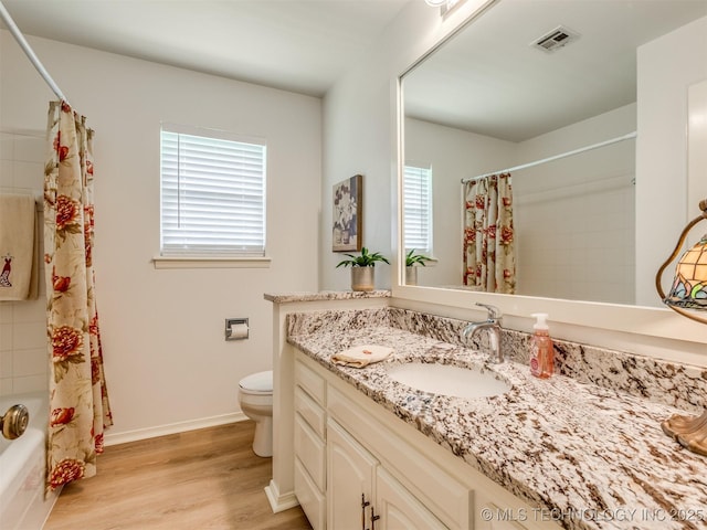 5610 S 75th E Pl, Tulsa, OK 74145 - full bath with vanity, plenty of natural light, wood finished floors, and shower / tub combo with curtain