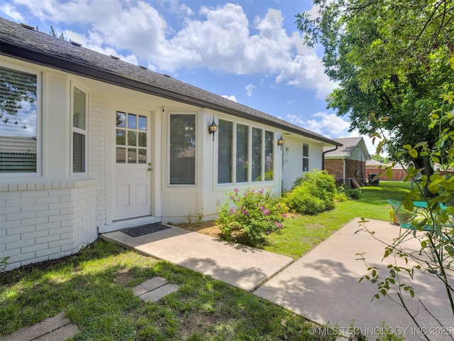 5610 S 75th E Pl, Tulsa, OK 74145 - view of exterior entry with brick siding and a patio