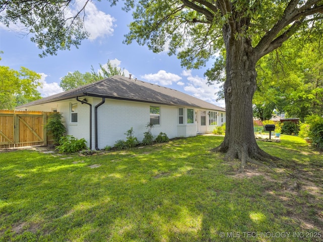 5610 S 75th E Pl, Tulsa, OK 74145 - back of house with brick siding and roof with shingles