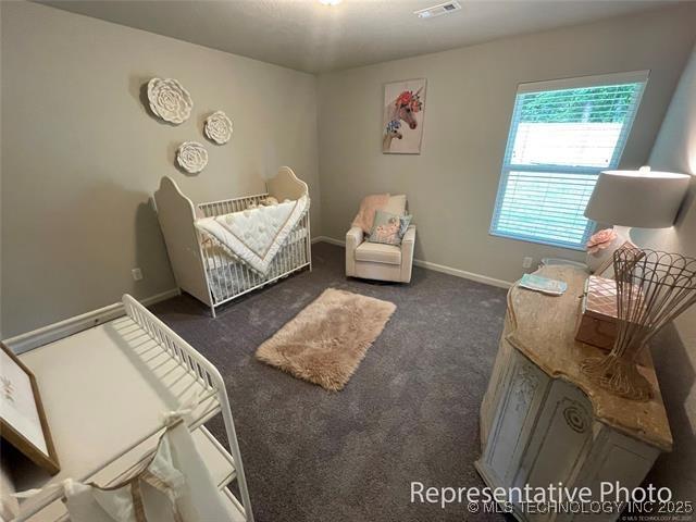 1414 N 83rd St, Broken Arrow, OK 74014 - bedroom with a crib and carpet flooring
