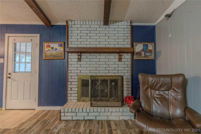 920 Ridge Oak Rd, Sapulpa, OK 74066 - living area with a textured ceiling, beam ceiling, wood finished floors, wood walls, and a brick fireplace