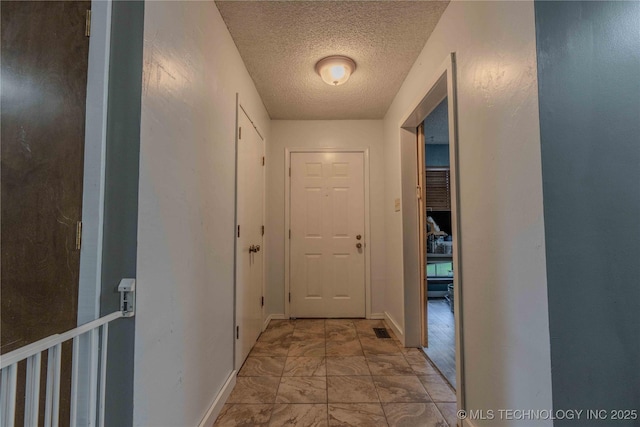 920 Ridge Oak Rd, Sapulpa, OK 74066 - hall featuring a textured ceiling and baseboards