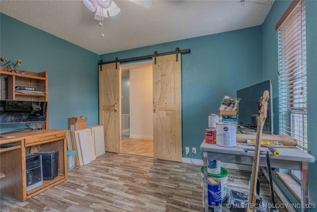920 Ridge Oak Rd, Sapulpa, OK 74066 - office space featuring a barn door, wood finished floors, a ceiling fan, and a textured ceiling