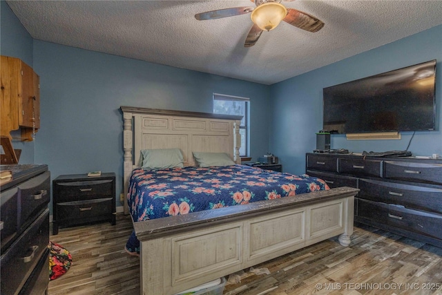 920 Ridge Oak Rd, Sapulpa, OK 74066 - bedroom with wood finished floors, a textured ceiling, and ceiling fan