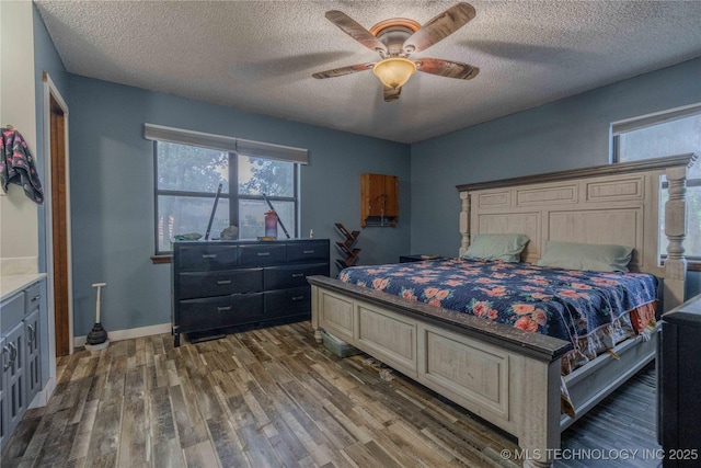 920 Ridge Oak Rd, Sapulpa, OK 74066 - bedroom featuring dark wood-style flooring, a textured ceiling, and ceiling fan