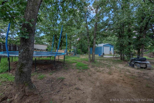 920 Ridge Oak Rd, Sapulpa, OK 74066 - view of yard with a trampoline, a storage unit, and a detached garage
