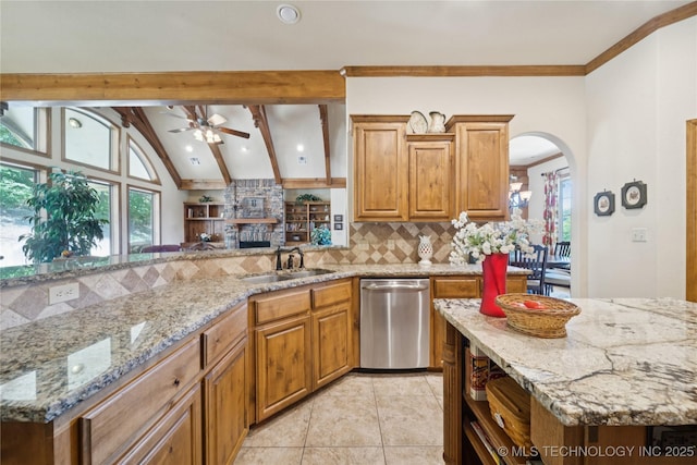 7355 E 453rd Rd, Claremore, OK 74017 - kitchen with dishwasher, a ceiling fan, decorative backsplash, arched walkways, and light tile patterned flooring