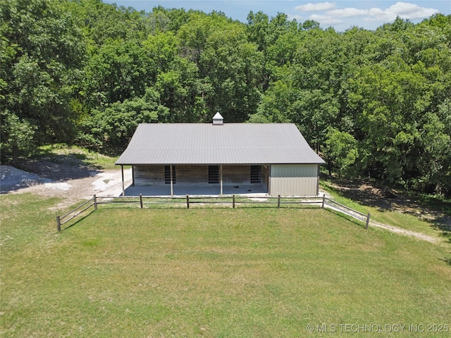 7355 E 453rd Rd, Claremore, OK 74017 - view of front of property with an exterior structure, a view of trees, an outbuilding, and a metal roof