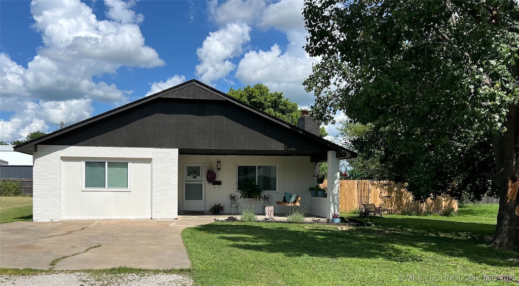 116 S Shawnee Ave, Dewey, OK 74029 - view of front of house with a chimney and concrete driveway