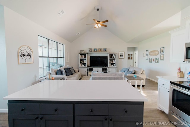11940 County Road 3513, Ada, OK 74820 - kitchen with stainless steel appliances, open floor plan, ceiling fan, white cabinetry, and high vaulted ceiling