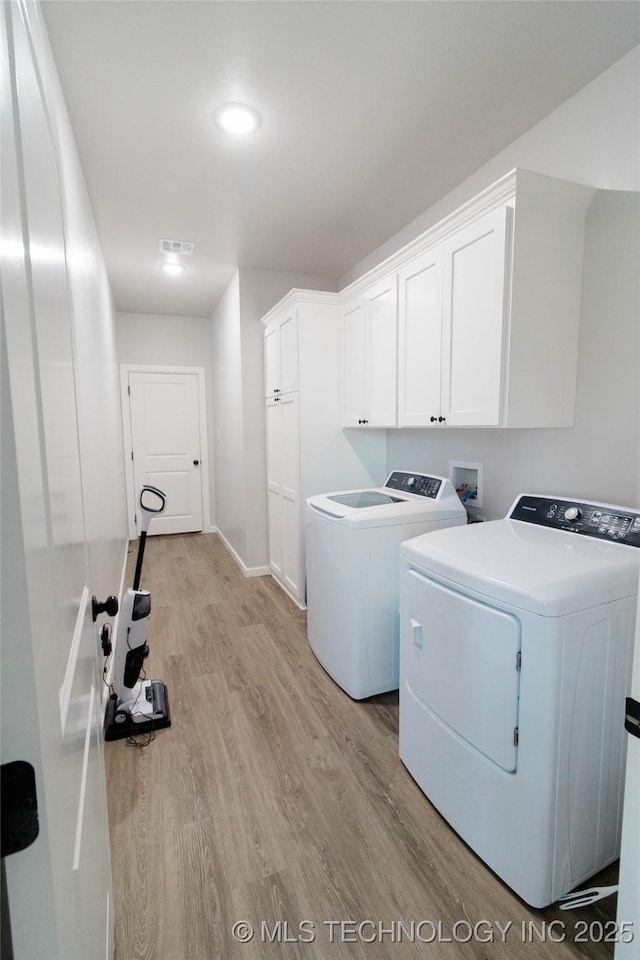 11940 County Road 3513, Ada, OK 74820 - laundry area featuring light wood-style floors, cabinet space, and independent washer and dryer