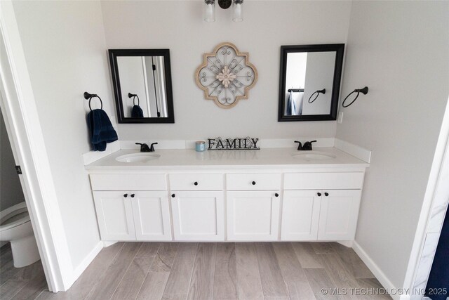 11940 County Road 3513, Ada, OK 74820 - full bath with double vanity and wood finished floors
