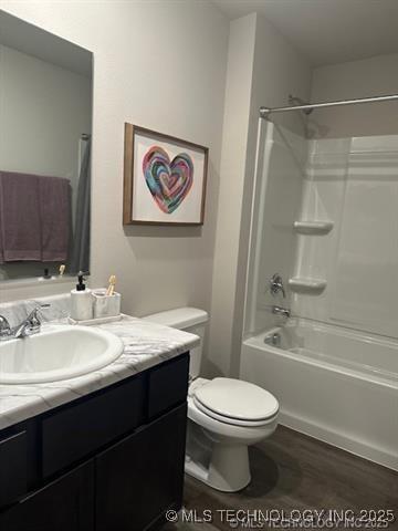 8308 E Oakland St, Broken Arrow, OK 74014 - full bathroom with vanity, tub / shower combination, and wood finished floors