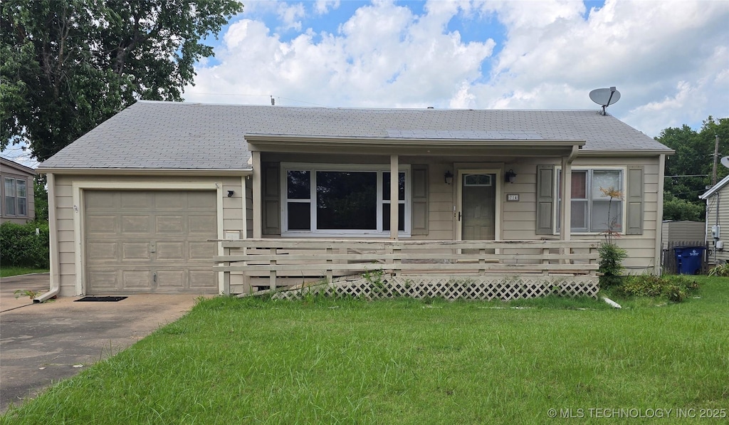 714 W Shawnee Ave, Nowata, OK 74048 - ranch-style home featuring covered porch, a shingled roof, a front yard, concrete driveway, and a garage