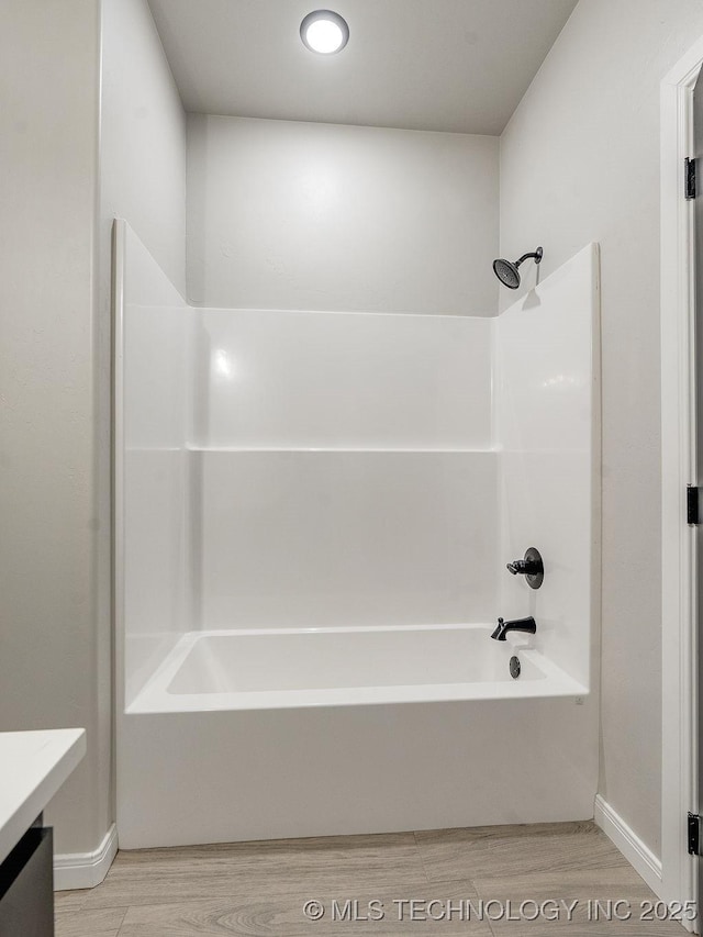 12098 County Road 3513th Loop, Ada, OK 74820 - bathroom with wood finished floors, vanity, and  shower combination