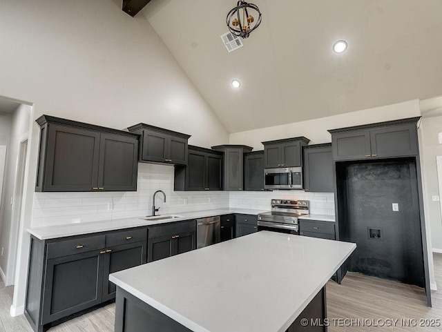 12098 County Road 3513th Loop, Ada, OK 74820 - kitchen with appliances with stainless steel finishes, light countertops, light wood-style flooring, high vaulted ceiling, and recessed lighting
