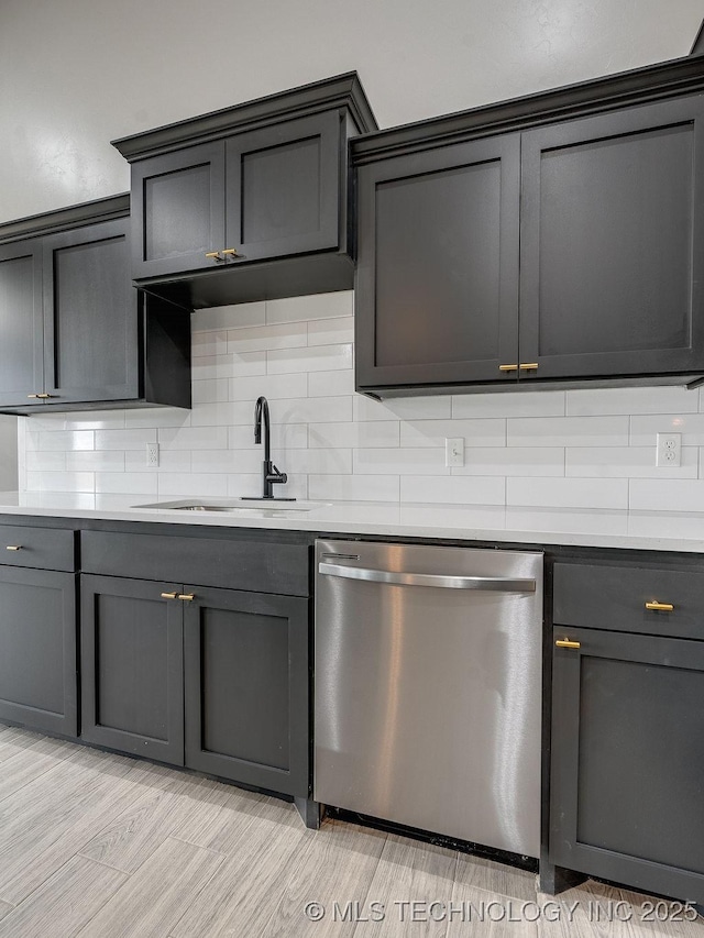 12098 County Road 3513th Loop, Ada, OK 74820 - kitchen featuring stainless steel dishwasher, decorative backsplash, light countertops, and light wood-style flooring
