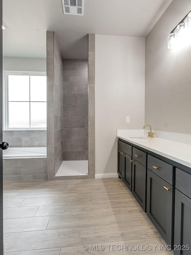 12098 County Road 3513th Loop, Ada, OK 74820 - bathroom with vanity, a garden tub, and a tile shower