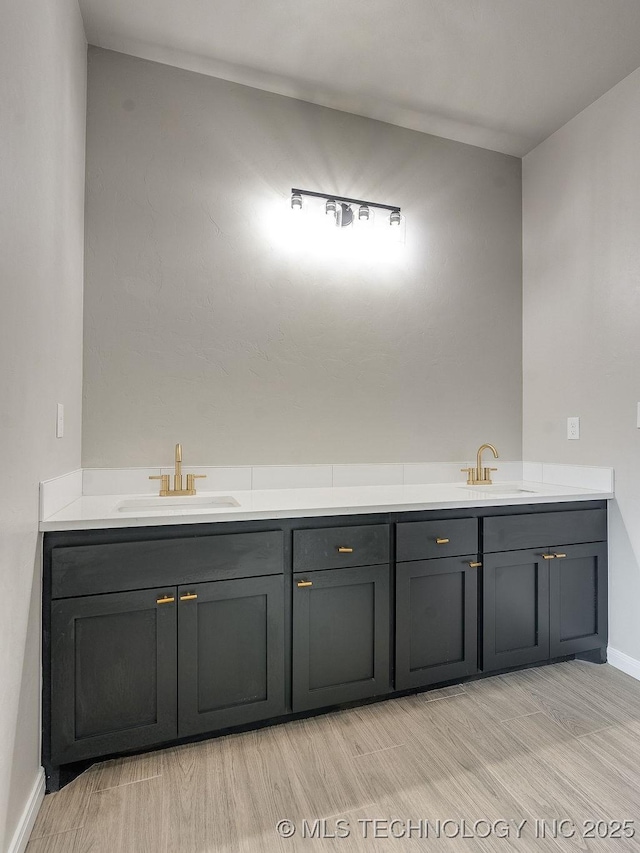 12098 County Road 3513th Loop, Ada, OK 74820 - full bathroom featuring double vanity and wood finished floors