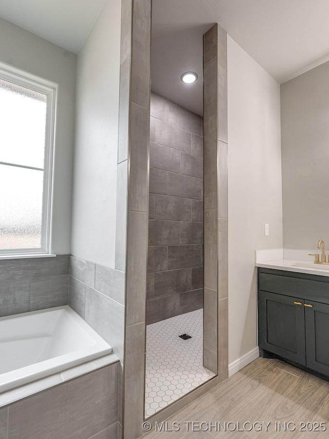 12098 County Road 3513th Loop, Ada, OK 74820 - bathroom with a garden tub, tiled shower, vanity, and wood finished floors