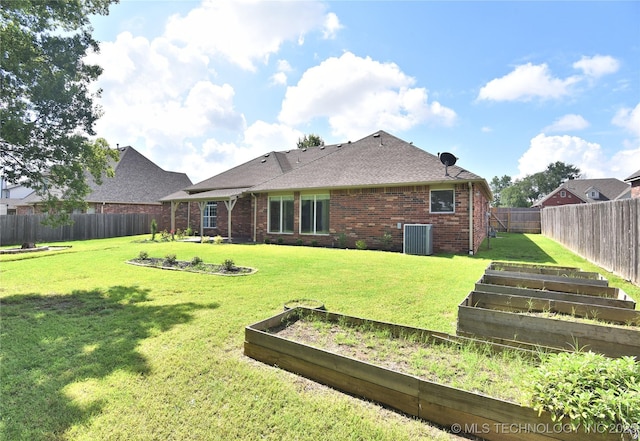1004 E Fargo St S, Broken Arrow, OK 74012 - back of property featuring a vegetable garden, brick siding, a fenced backyard, and a shingled roof