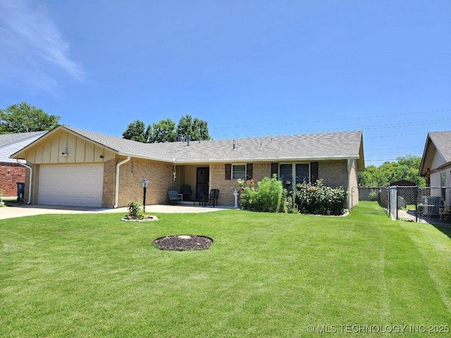 2449 S 144th E Ave, Tulsa, OK 74134 - ranch-style house with an attached garage, brick siding, concrete driveway, and board and batten siding