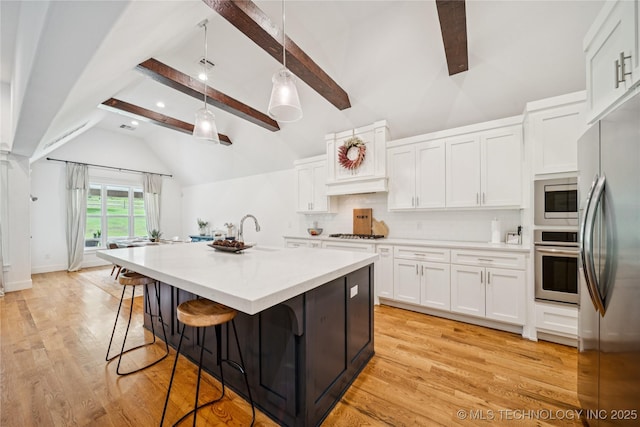 7383 S 288th E Ave, Broken Arrow, OK 74014 - kitchen featuring white cabinetry, a breakfast bar, tasteful backsplash, appliances with stainless steel finishes, and light countertops