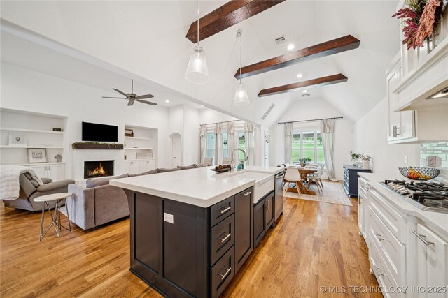 7383 S 288th E Ave, Broken Arrow, OK 74014 - kitchen with white cabinets, a ceiling fan, light countertops, a warm lit fireplace, and recessed lighting