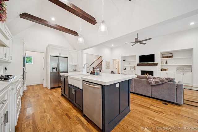 7383 S 288th E Ave, Broken Arrow, OK 74014 - kitchen featuring white cabinets, ceiling fan, beam ceiling, appliances with stainless steel finishes, and light countertops